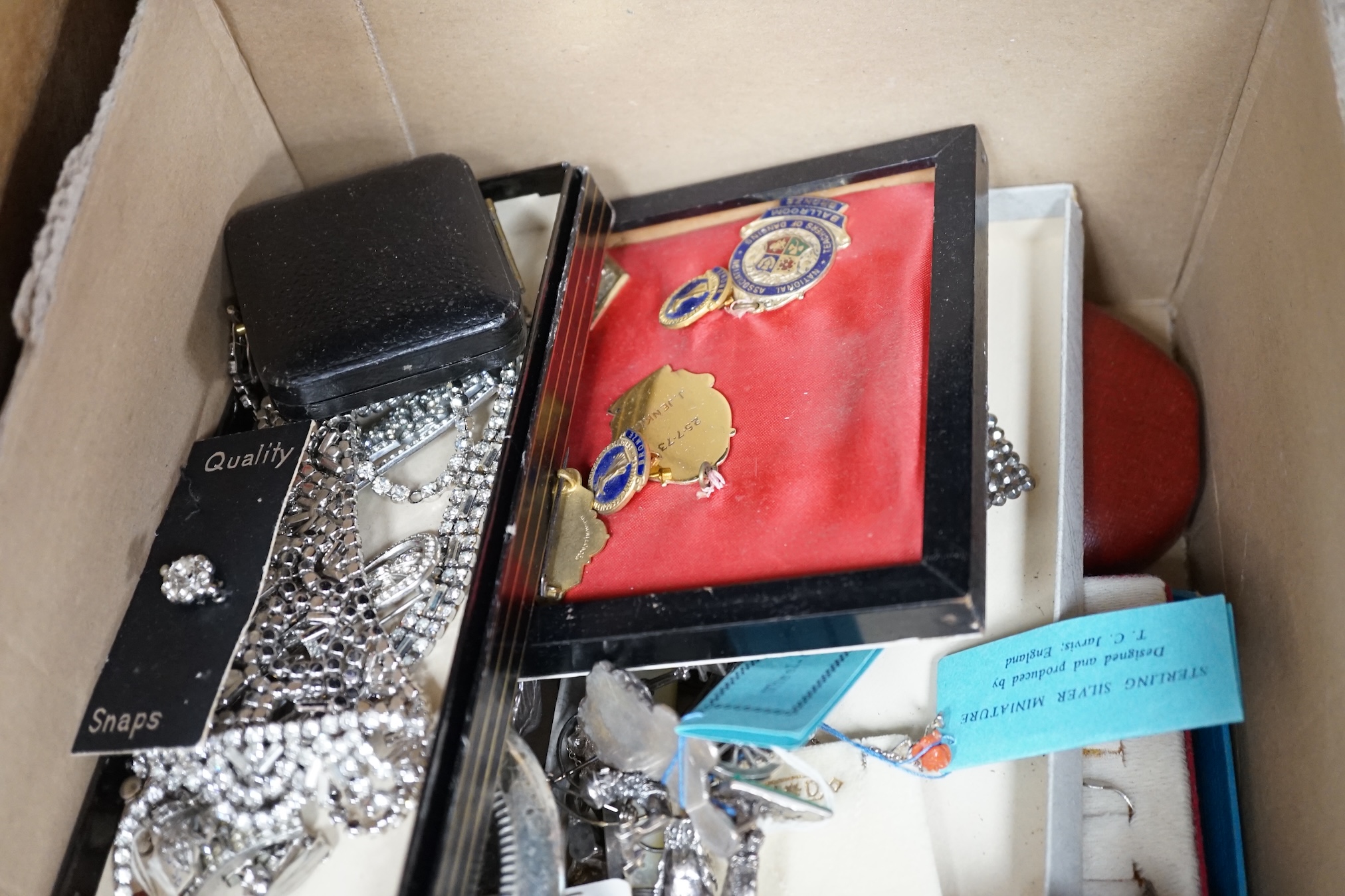 A large quantity of assorted costume jewellery including modern silver miniature figures etc. Condition - fair